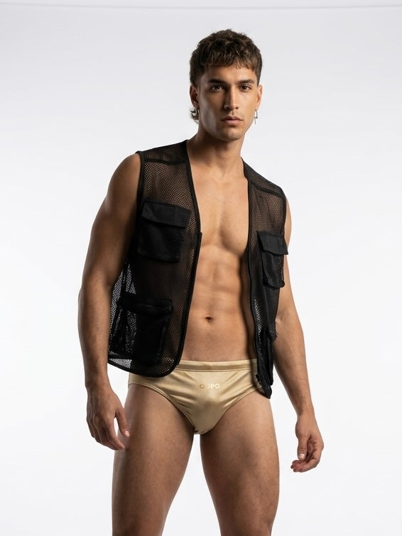 Man wearing a black mesh vest over gold swimwear