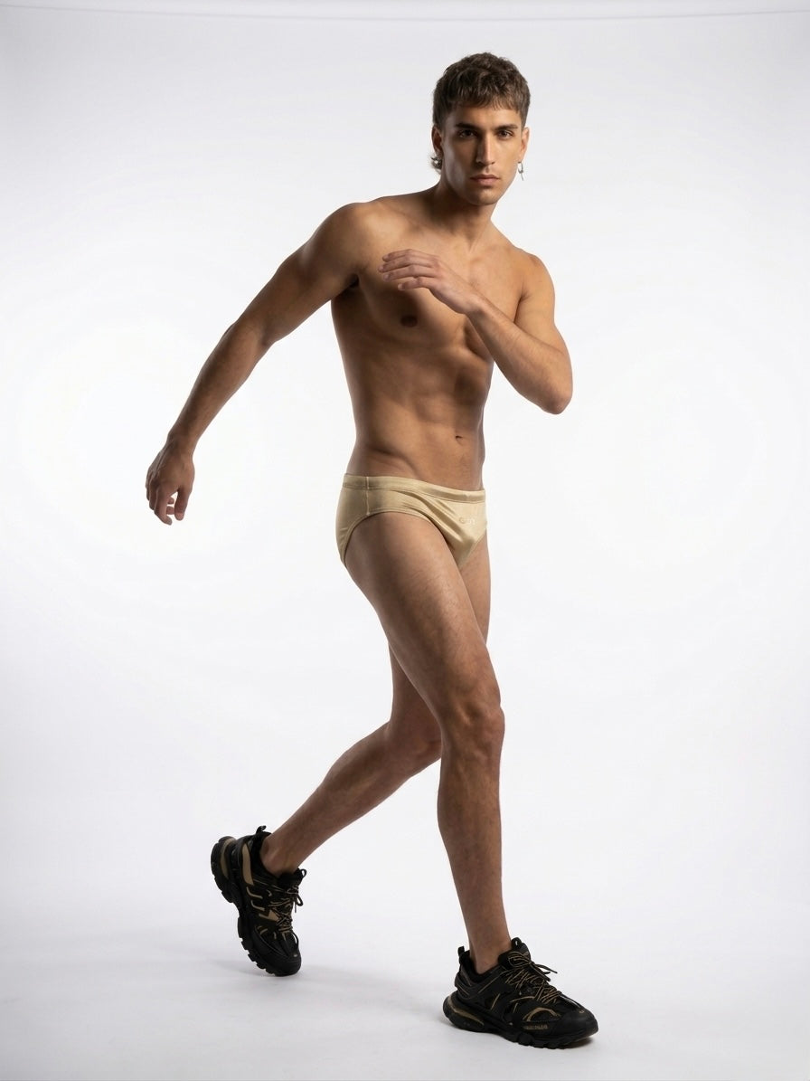 Male model wearing gold swim speedo by GODO