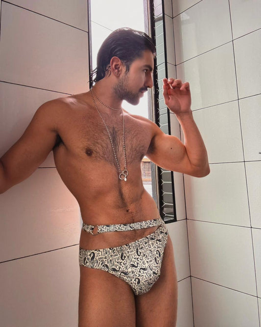 Man wearing patterned swimwear in a bathroom setting