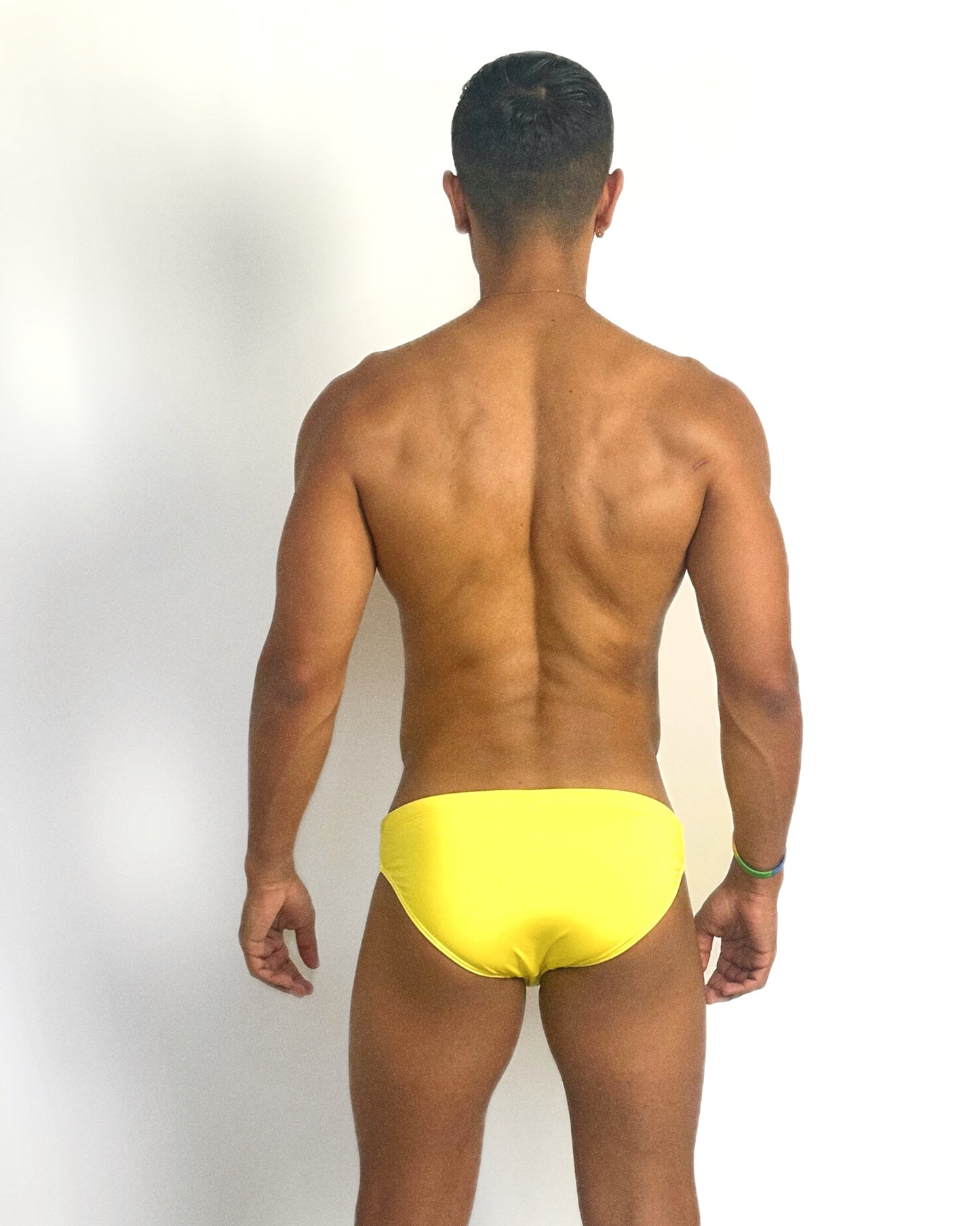Latin guy in yellow underwear showing his back